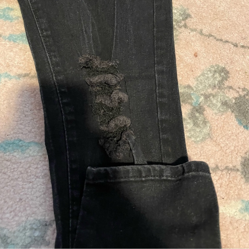 Black distressed jeans with rips on the knees and a button fly - Picture 3 of 6